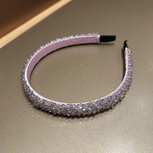 Detailed view of pink woven headband featuring sparkling purple faceted crystal beads