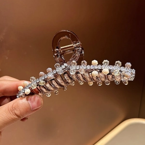 Detail of amber claw clip with crystal beads and sparkling rhinestones for hair