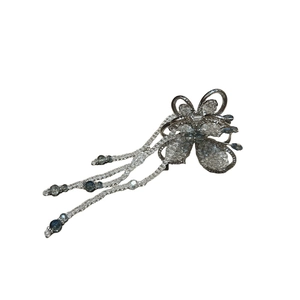 Elegant butterfly claw clip with silver crystals and blue beaded tassels on white background