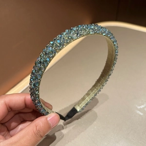 Close-up of sparkling blue crystal beads on a hand-woven wide headband