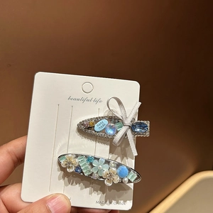 Close-up of elegant silver hair clips with sparkling rhinestones and handmade butterfly