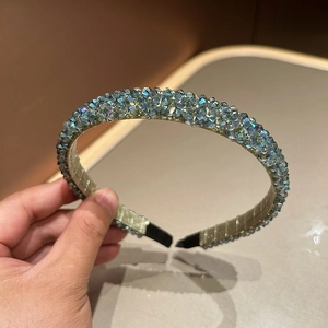 Detailed view of handmade crystal beaded headband with iridescent shimmering beads