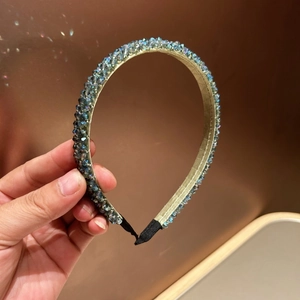 Detail of handcrafted grey-blue crystal beaded headband with vintage woven wide band texture