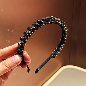 Close-up of double-layered headband with black and iridescent multi-faceted crystal beads