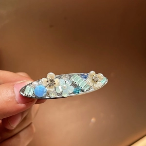 Floral alloy hair clip with sky blue bead and mint crystals for a sweet summer style