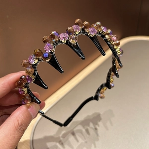 Black resin headband with purple and amber crystals and built-in hair clips for styling