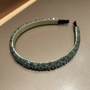 Detail of hand-woven headband with blue-grey crystal beads and champagne leather lining