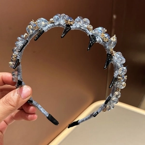 Detailed view of light blue crystal beaded headband with anti-slip inner shark teeth comb