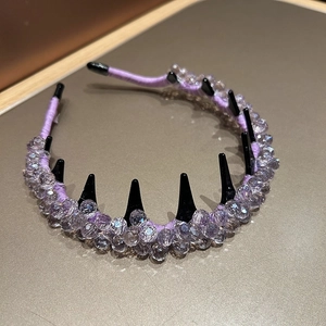 Detail of light purple crystal headband with black comb teeth for securing hair