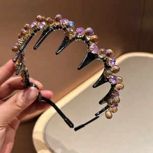 Luxurious crystal headband with purple and amber gems on a black toothed hair hoop