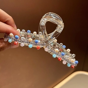 Detail of shark hair claw clip with colorful crystal beads and sparkling rhinestones