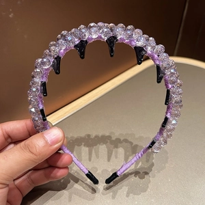 Detail showing purple crystal headband with non-slip teeth and sparkling beads