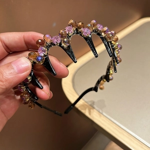 Detail of crystal headband showing purple and amber beads with anti-slip inner teeth