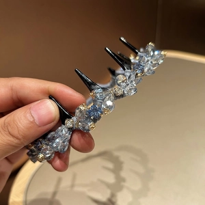 Macro shot of luxury crystal beaded headband with navy blue and clear faceted gems