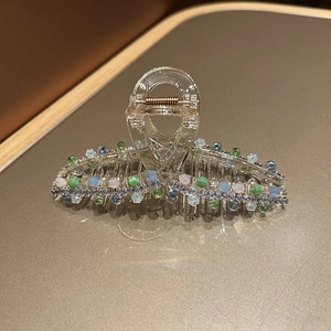 Macro detail of elegant hair claw with colorful crystal beads and sparkling rhinestones