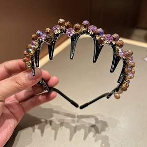 Detailed macro view of vintage crystal headband with purple and amber faceted beads