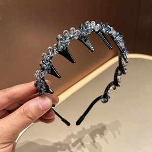 Close-up of sparkling blue-grey crystal beads on a non-slip black headband with comb teeth