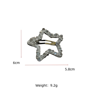 Star-shaped crystal hair clip detail showing dimensions 6cm by 5.8cm and 9.2g weight