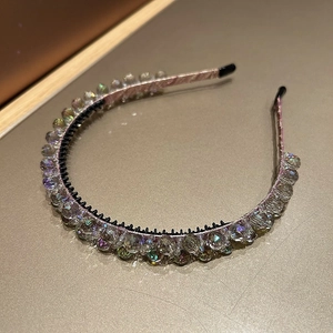 Close-up of sparkling crystal beads and pink fabric wrap on the double-layered headband