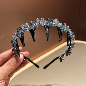 Detail shot of blue and clear crystal beads on a black non-slip toothed headband