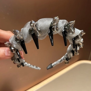 Detailed shot of dark gothic headband featuring grey mesh and black long cone spike charms