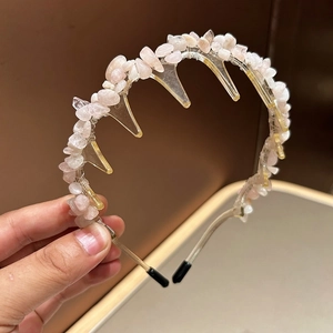 Close-up of a pink natural stone headband featuring non-slip teeth and resin base