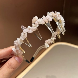 Detailed view of pink natural stone headband with non-slip teeth for secure styling