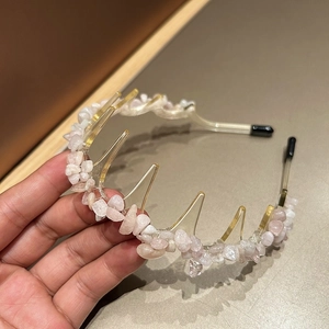 Close-up of pink crystal natural stone non-slip headband with amber resin and teeth
