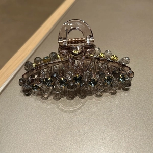 Detail of grey crystal hair claw featuring hand-crafted beads and sparkling rhinestones