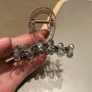 Detailed view of medium hair claw with grey crystals and brown resin finish