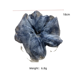 Detail view of a 18cm sparkling grey blue organza scrunchie with silver glitter texture