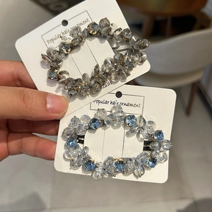 Sparkling crystal beaded hair clips in blue and grey on a white display card