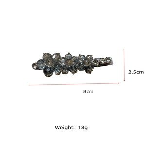 Detail view of floral crystal hair clip with dimensions of 8cm x 2.5cm and 18g weight
