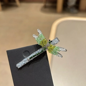Exquisite crystal dragonfly hair clip with vibrant green beads on silver metal base