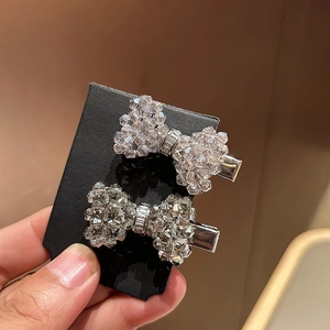Set of two sparkling crystal bow hair clips with elegant rhinestones and silver metal finish