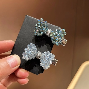 Sparkling crystal bow hair clips set in iridescent teal and light blue colors