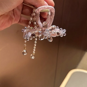 Elegant silk fabric hair claw clip with crystal flowers and hanging tassel detail