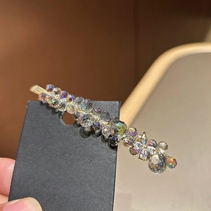 Exquisite gold hair clip with sparkling ice blue crystals and shimmering rhinestones