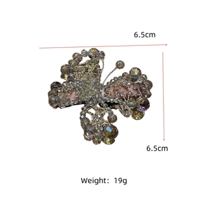 Detail view of handmade beaded butterfly hair clip with champagne crystals measuring 6.5 cm