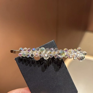 Exquisite blue crystal hair clip with iridescent beads and diamonds on a black card