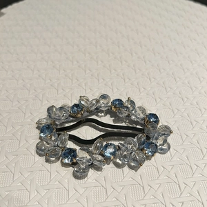 Detail of light blue crystal hair clip with handmade beaded design on a metal BB clip