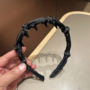 Close-up of black satin woven headband with anti-slip teeth and sparkling rhinestones