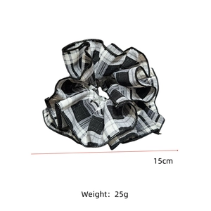 Macro detail of extra large 15cm checkered scrunchie with high density pleated fabric