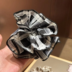 Chic black and white plaid scrunchie with pleated fabric and high-quality edge stitching