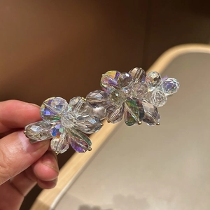 Sparkling crystal flower hair clip with iridescent beads on a silver spring claw clip