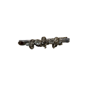 Elegant silver-grey silk fabric hair clip with shimmering crystal clusters and metal tag