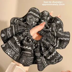 Detail of extra large navy blue paisley scrunchie with 20cm diameter and fabric pleats