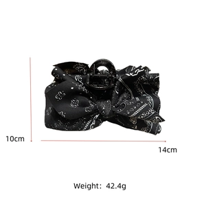 Detailed view of black floral bow hair claw clip showing 14cm length and 10cm height