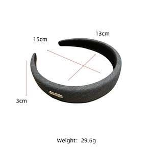 Detail showing dimensions of gray striped fabric headband with golden metal hardware detail