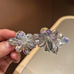 Detail showing handcrafted iridescent crystal beads on dual-flower hair clip design